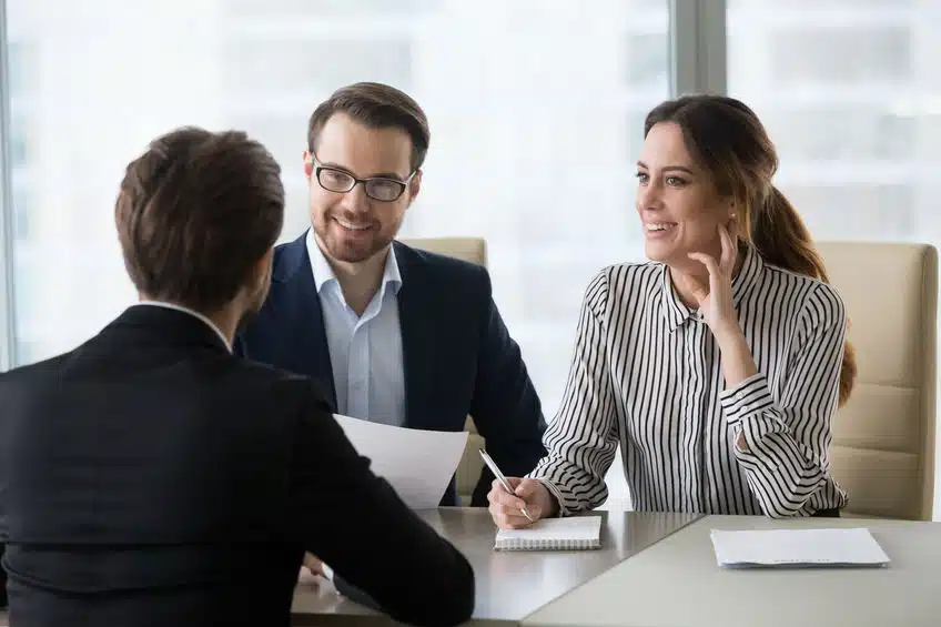 excited hr managers smiling liking male job applicant during int