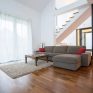 Wooden parquet and small carpet in living room